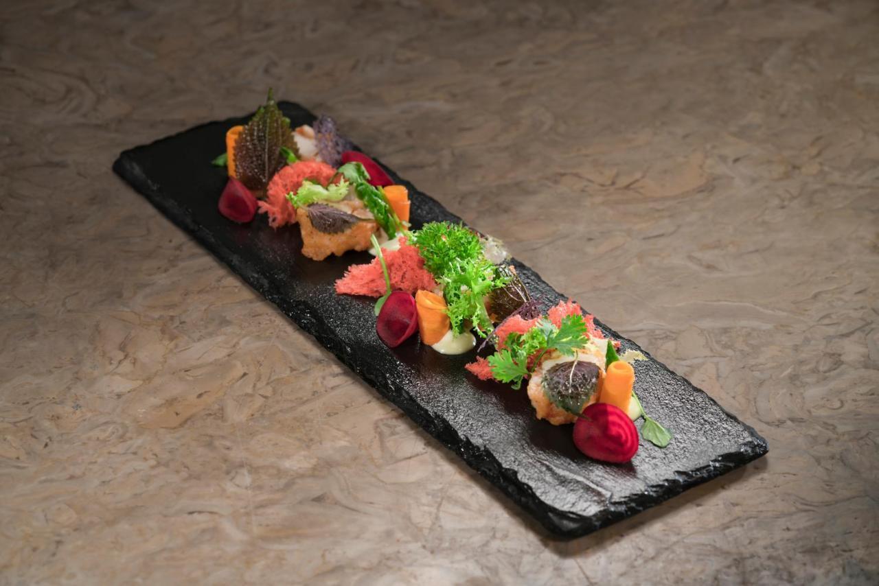 Vinpearl Resort & Spa Phu Quoc Exterior photo A salad on a slate plate